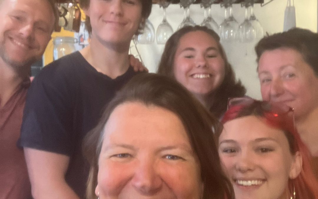 Group of people huddled together taking a selfie with Ellie Chowns MP.