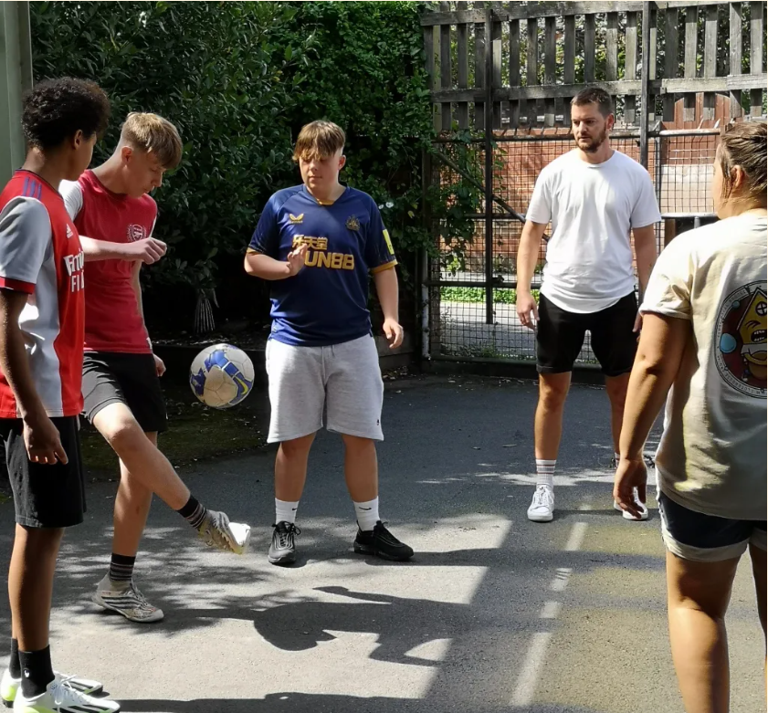 young boys are playing football