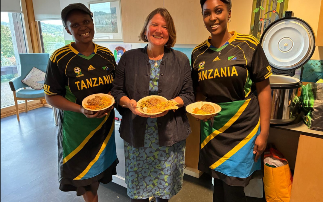 Ellie is standing with two ladies from Tanzania