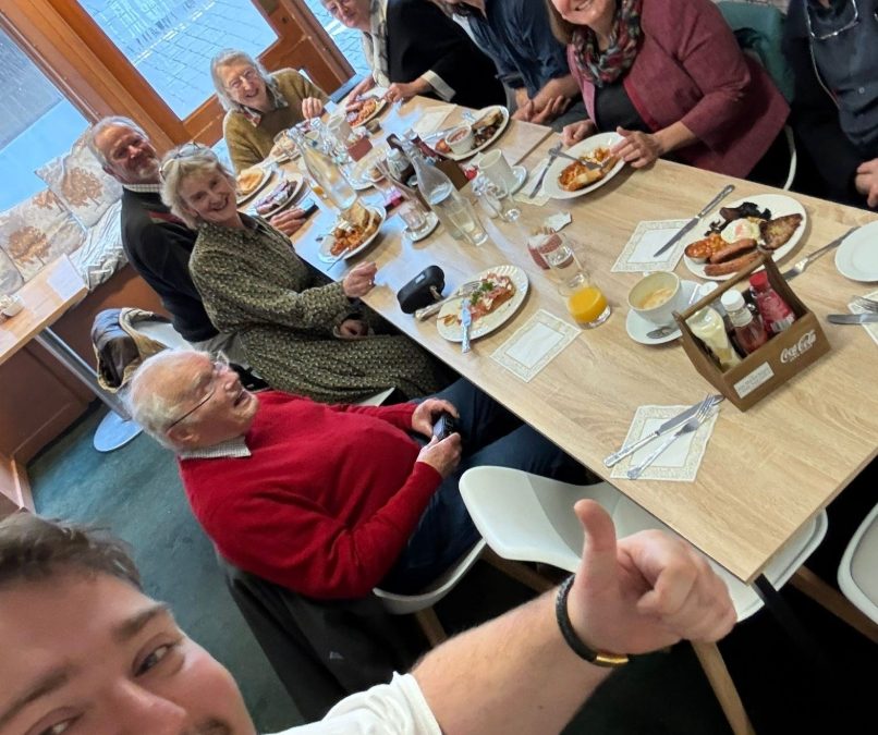 People sat at the table, having lunch and smiling